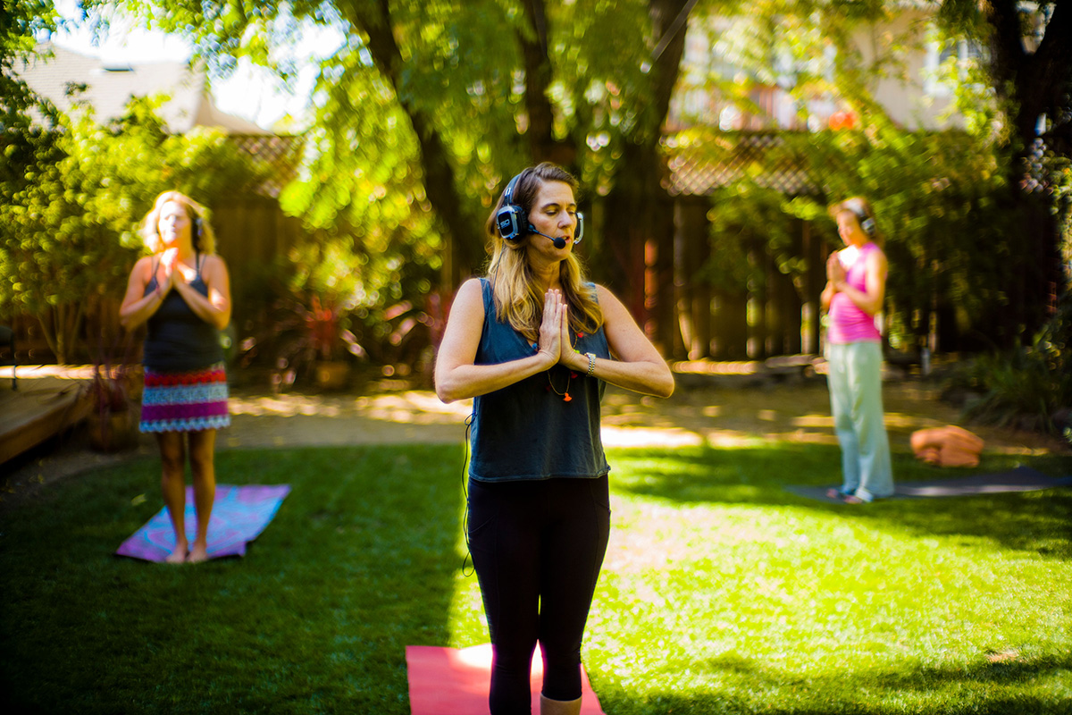 Women in yoga poses wearing headphones
